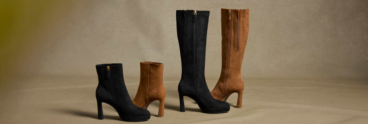 Four knee-high heeled boots in black and brown suede-like material, arranged on a warm beige studio background.