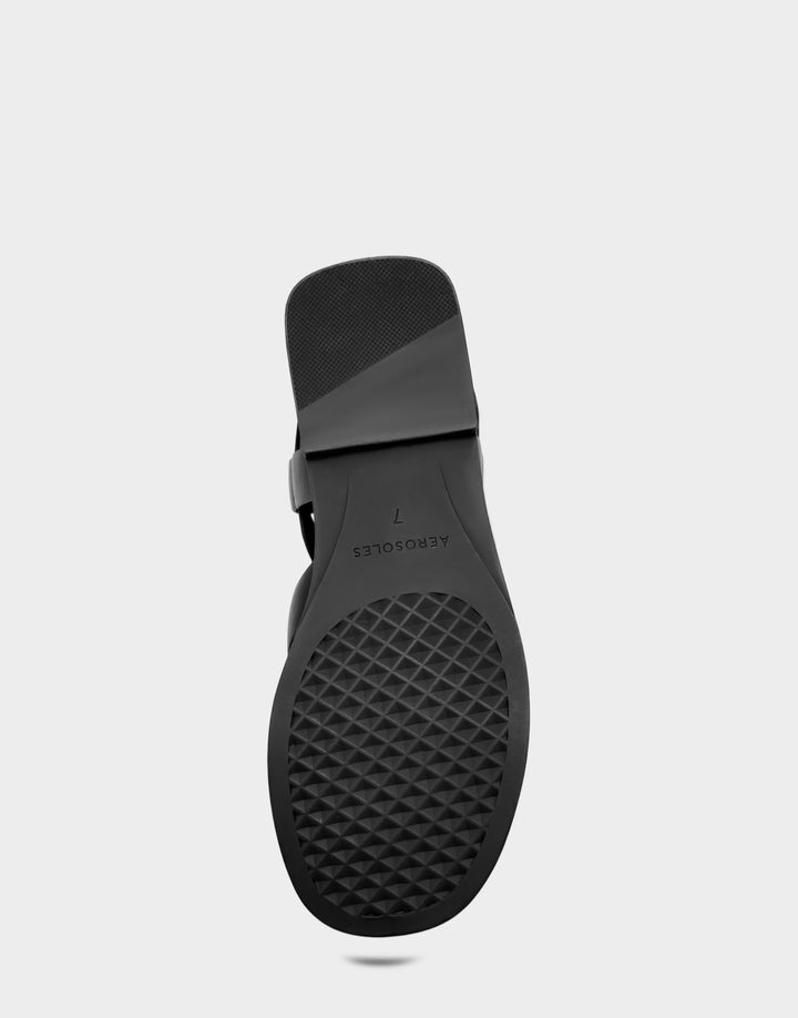 Comfortable Women's Flat Sandal in Black Faux Leather Bottom View