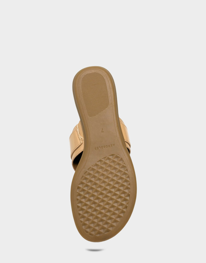 Comfortable Women's Flat Sandal in Natural Faux Patent Bottom View