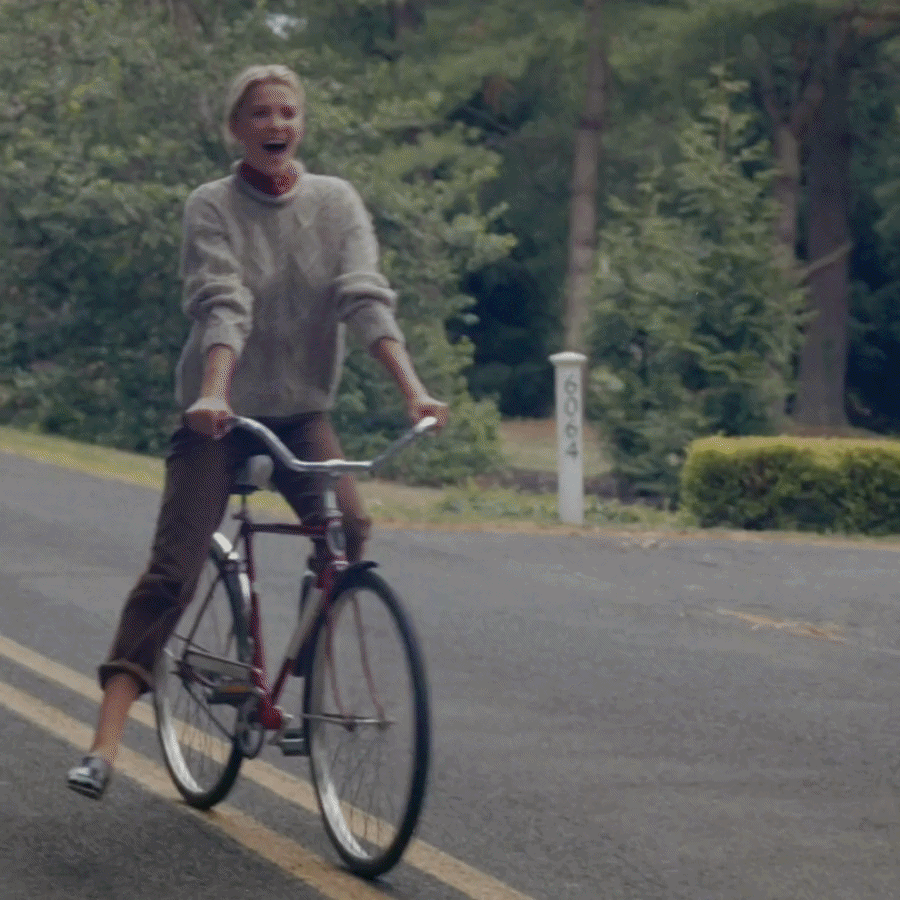 gif of woman riding bike wearing loafers